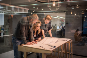 3 architects looking at plans